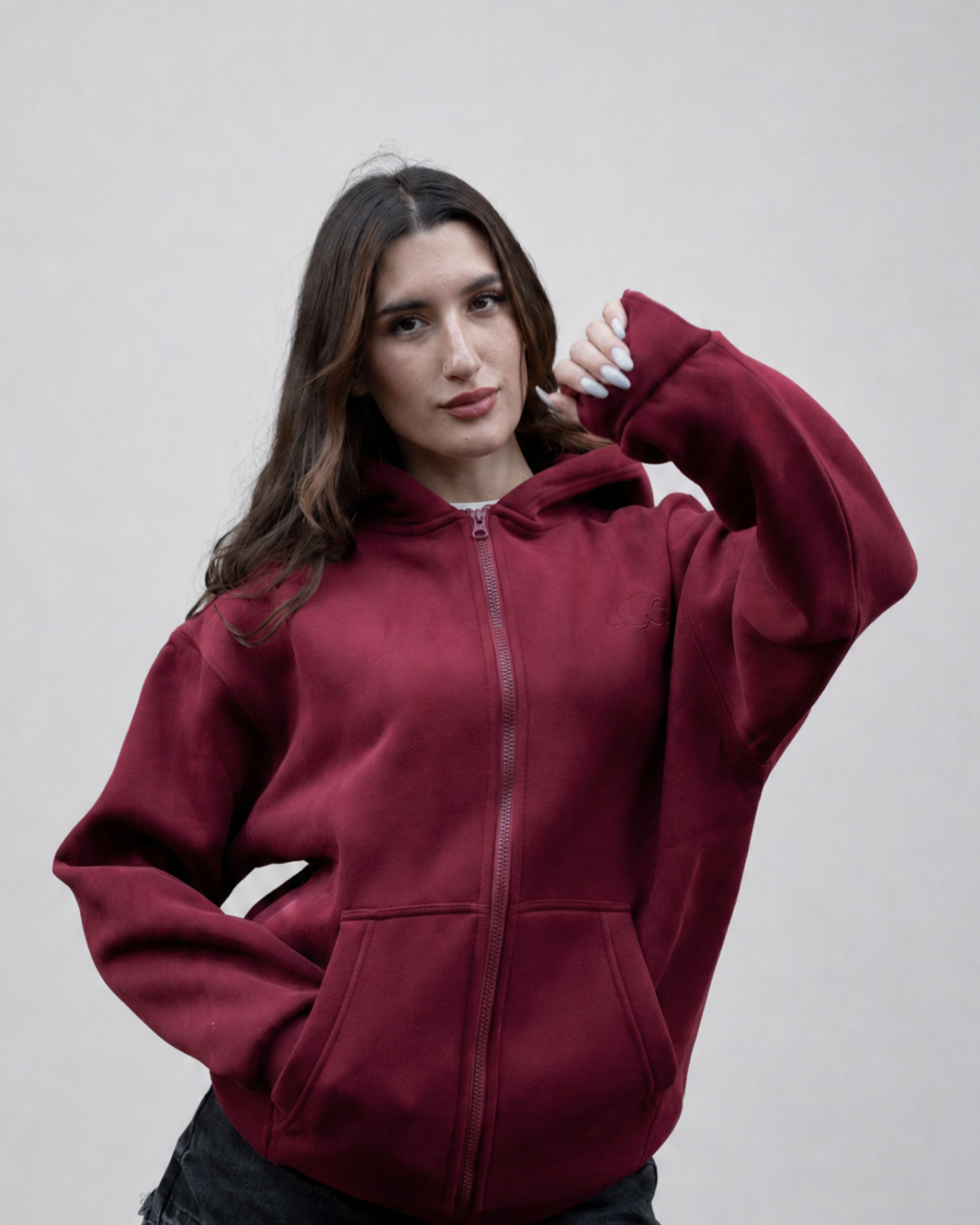 Grounding Zip-Up Hoodie in Burgundy – model squeezing stress ball