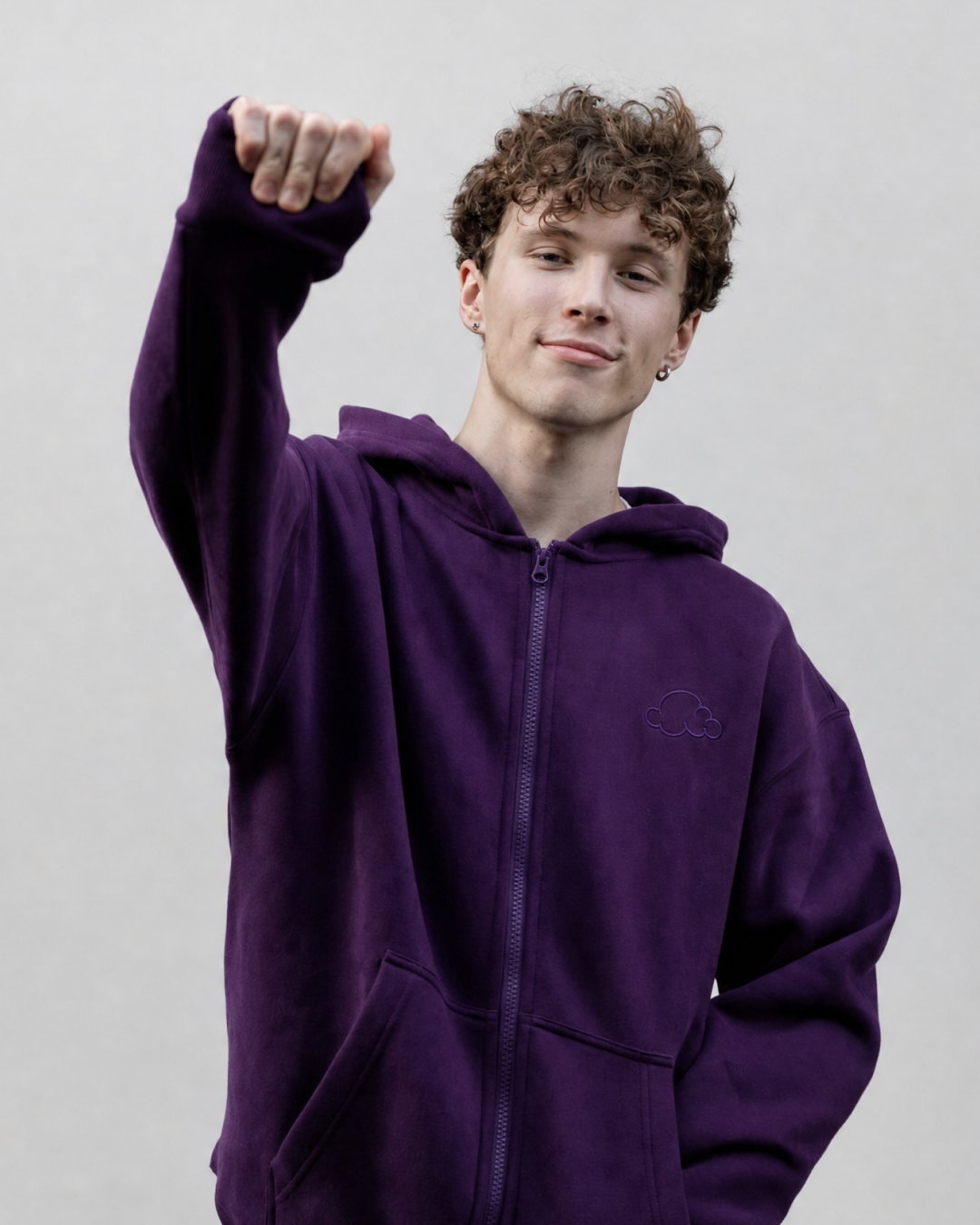 Grounding Zip-Up Hoodie in Plum – model squeezing stress ball