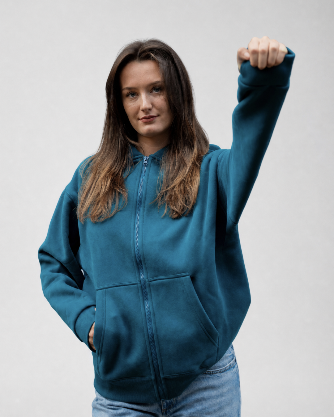 Grounding Zip-Up Hoodie in Teal – model squeezing stress ball